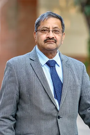 Rear view of a healthcare doctor himanshu garg walking down a hospital corridor