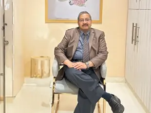 doctor himanshu garg sitting on a chair